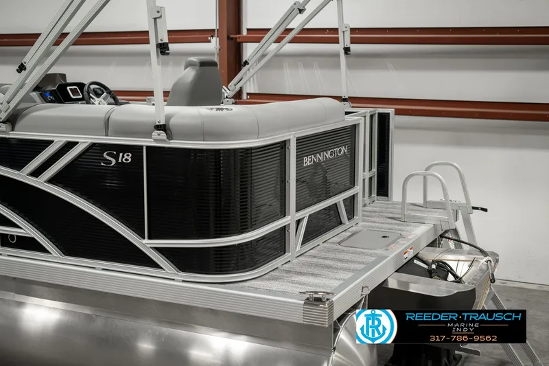 Slide: The Image of 2025 Bennington 118 SLS pontoon boat in showroom, featuring sleek design and modern amenities. - 46