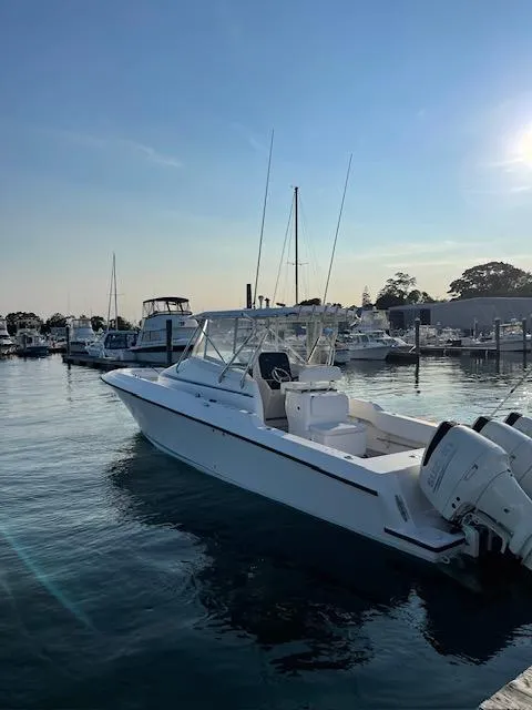 The Image of 2006 Contender 36 Fisharound boat docked in a marina under a clear blue sky. - 0