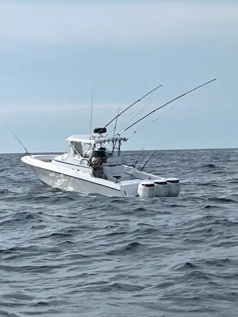 Slide: The Image of 2006 Contender 36 Fisharound boat on open sea with fishing rods. - 2