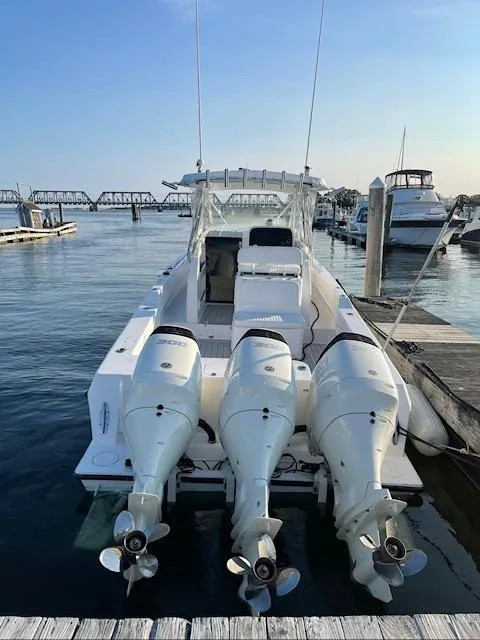 Slide: The Image of 2006 Contender 36 Fisharound boat docked with triple outboard engines. - 3