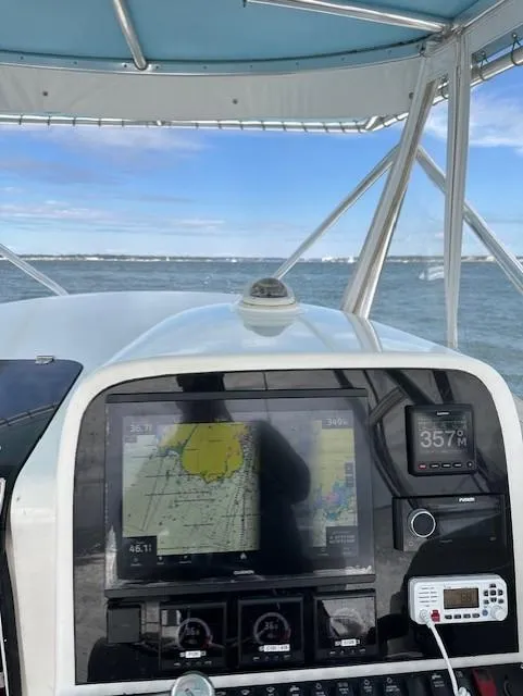 Slide: The Image of 2006 Contender 36 Fisharound boat dashboard with navigation equipment on open water. - 5