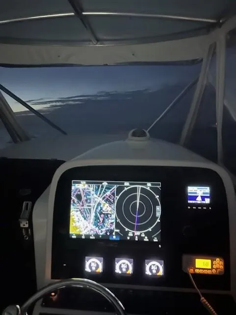 Slide: The Image of 2006 Contender 36 Fisharound boat dashboard with navigation screens at dusk. - 6