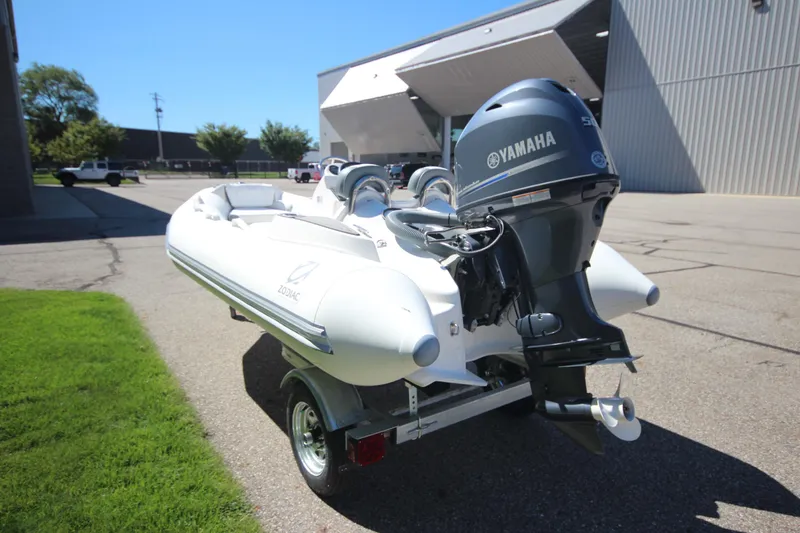 Slide: The Image of 2025 Zodiac Yachtline 400 DL with Yamaha 50hp engine on trailer, parked outdoors. - 4