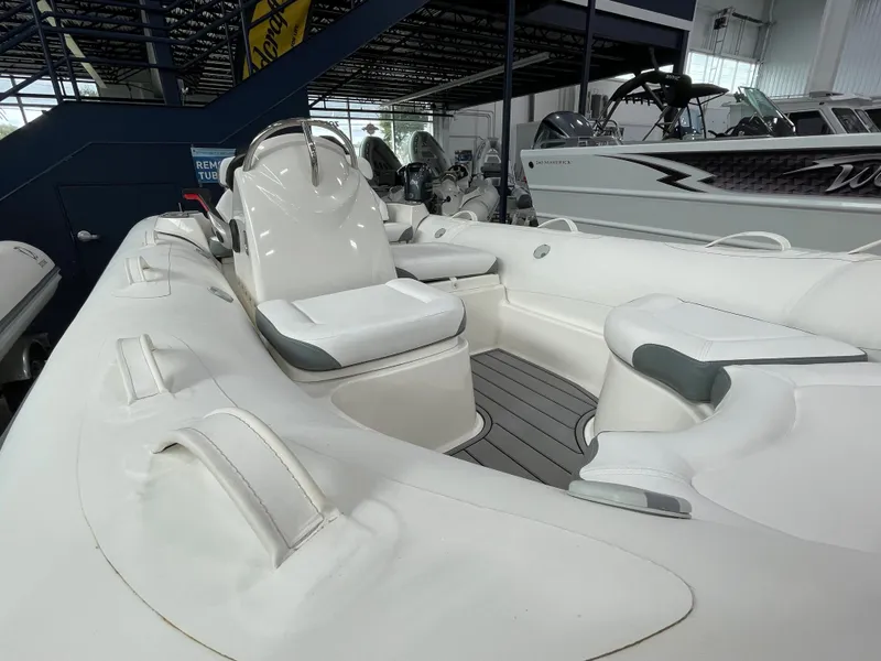 Slide: The Image of 2025 Zodiac Yachtline 490 Deluxe NEO 90hp, sleek white interior, luxury seating. - 32