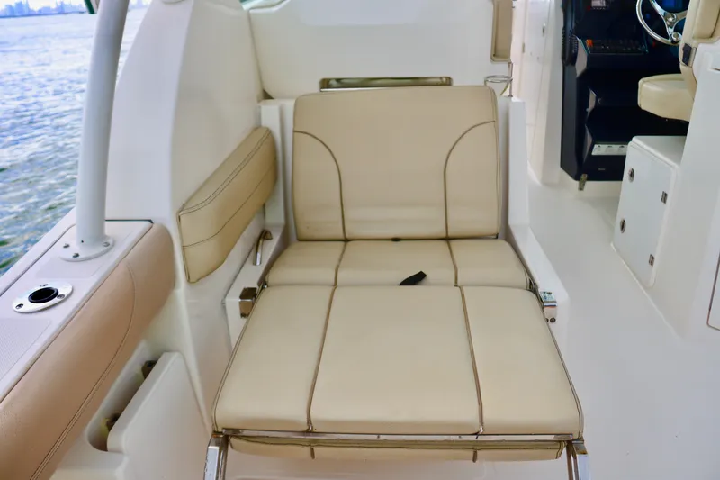 Slide: The Image of 2017 Pursuit DC 295 Dual Console boat interior with beige seating. - 10