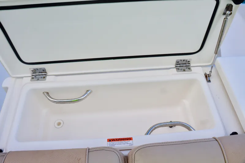 Slide: The Image of Open storage compartment on 2017 Pursuit DC 295 Dual Console boat. - 18