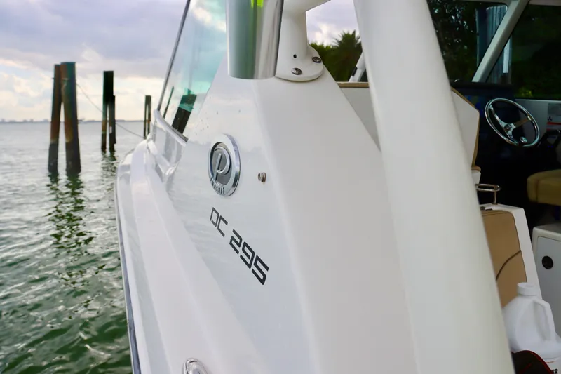 Slide: The Image of 2017 Pursuit DC 295 Dual Console boat on water, side view. - 21