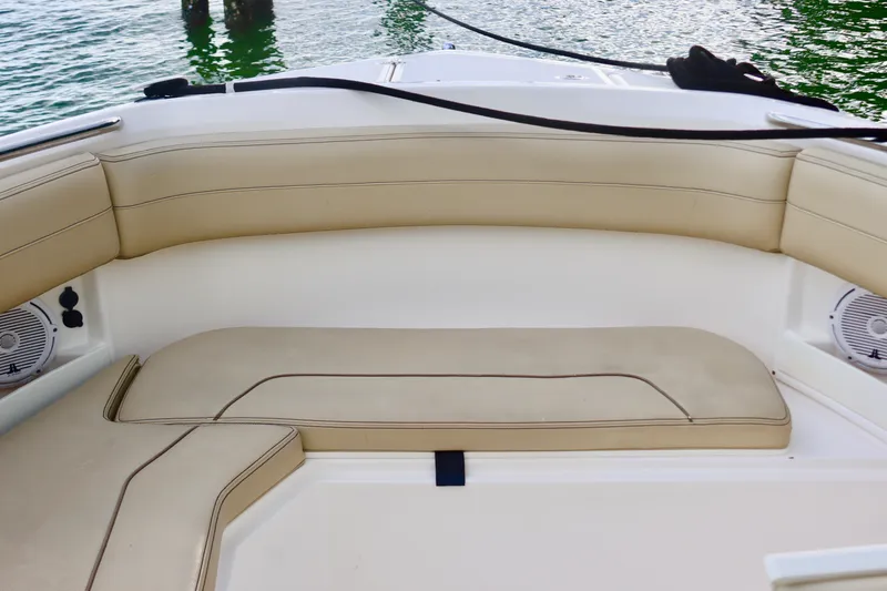 Slide: The Image of 2017 Pursuit DC 295 Dual Console boat with beige seating and water view. - 22