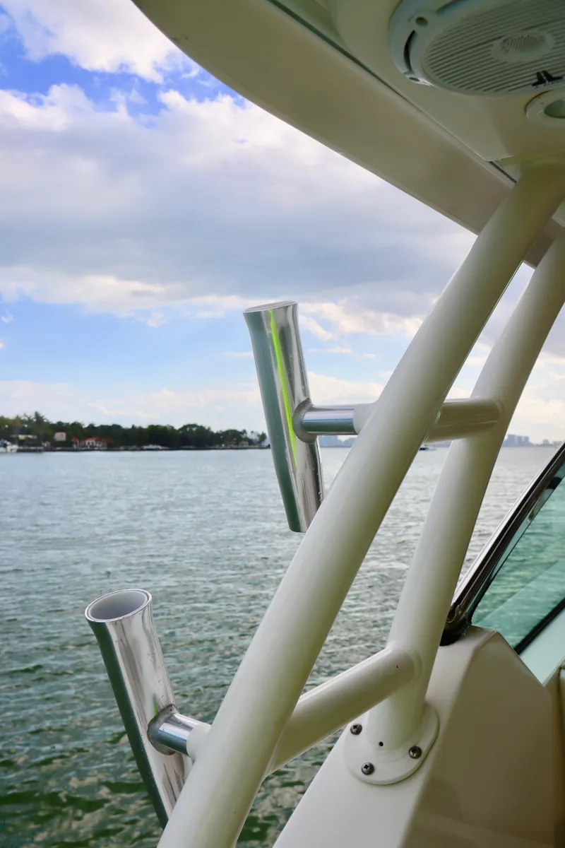 Slide: The Image of 2017 Pursuit DC 295 Dual Console boat with rod holders, scenic water view. - 26