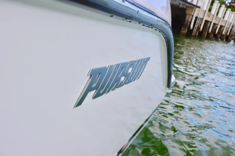 Slide: The Image of Close-up of 2017 Pursuit DC 295 Dual Console boat on water. - 27