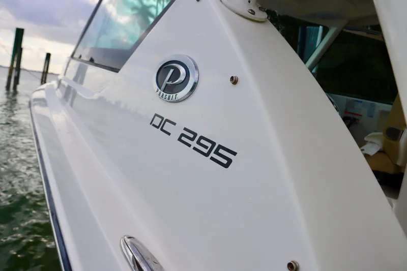 Slide: The Image of 2017 Pursuit DC 295 Dual Console boat on water, side view. - 28