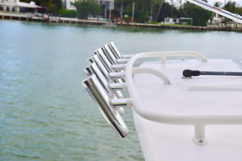 Slide: The Image of Stainless steel rod holders on 2017 Pursuit DC 295 Dual Console boat by the water. - 30