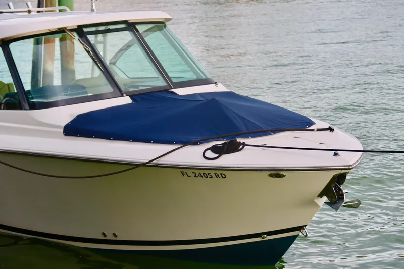 Slide: The Image of 2017 Pursuit DC 295 Dual Console boat docked on calm water. - 32