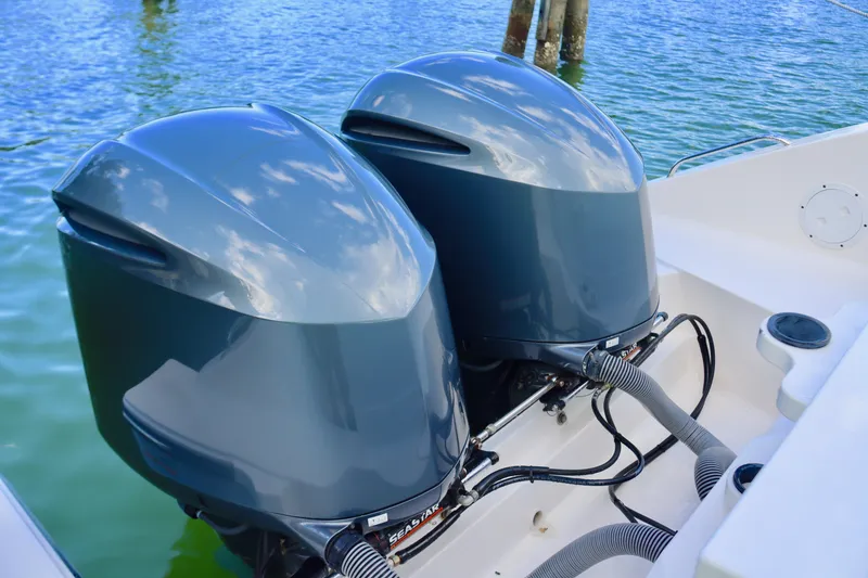 Slide: The Image of 2017 Pursuit DC 295 Dual Console with twin outboard engines on water. - 33