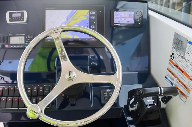 Slide: The Image of 2017 Pursuit DC 295 Dual Console dashboard with steering wheel and navigation controls. - 4