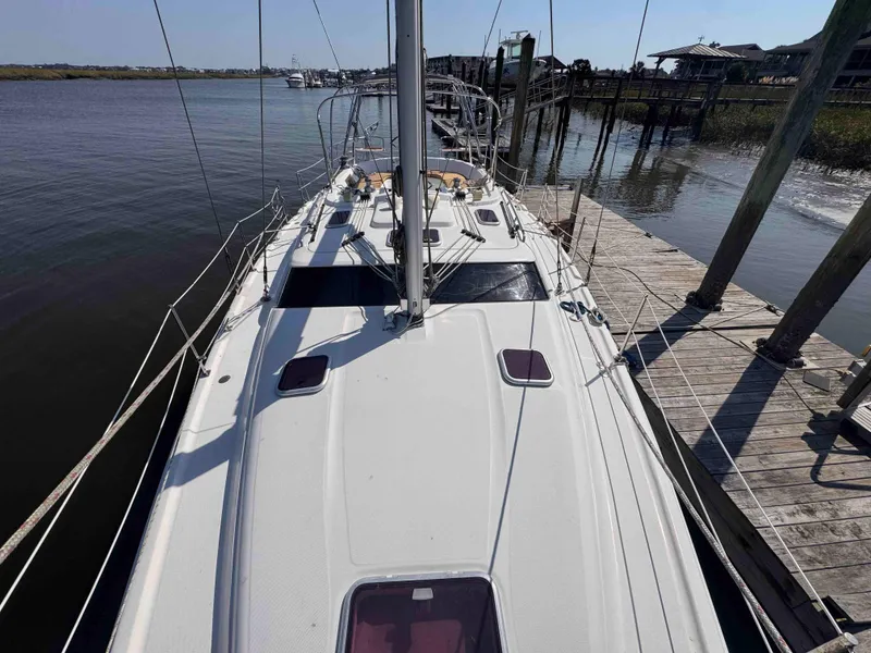 Slide: The Image of 2008 Hunter 45 Center Cockpit sailboat docked at a marina. - 14