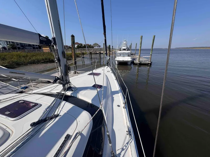 Slide: The Image of 2008 Hunter 45 Center Cockpit sailboat docked at a marina on a sunny day. - 16