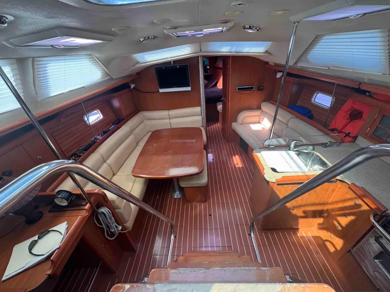 Slide: The Image of Interior of 2008 Hunter 45 Center Cockpit yacht with wood finish and seating area. - 19