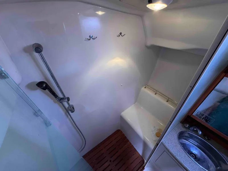 Slide: The Image of 2008 Hunter 45 Center Cockpit bathroom with shower, wooden seat, and stainless steel sink. - 24