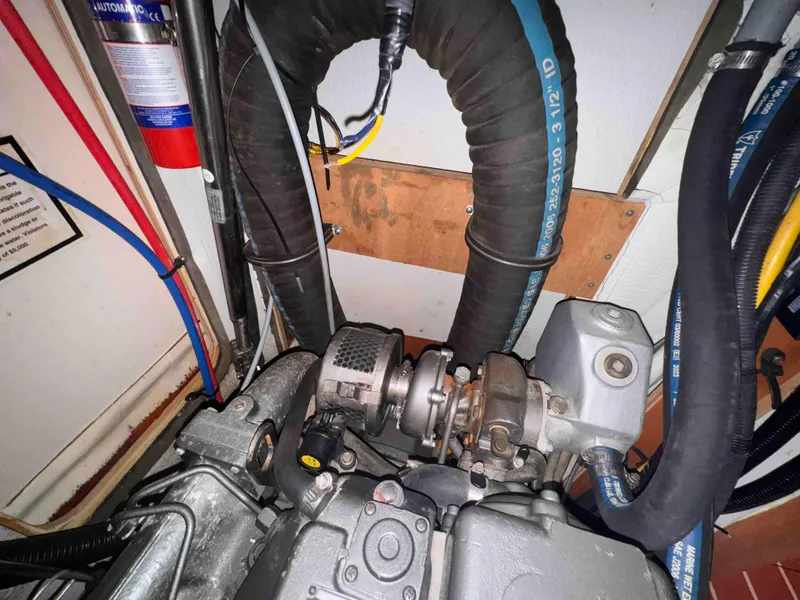 Slide: The Image of Engine compartment of a 2008 Hunter 45 Center Cockpit sailboat, showing mechanical components. - 28
