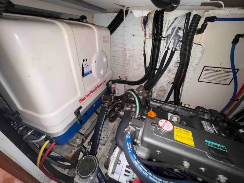 Slide: The Image of Engine room of 2008 Hunter 45 Center Cockpit sailboat with visible generator and wiring. - 30