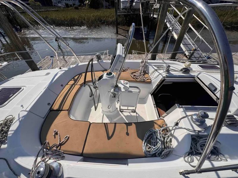Slide: The Image of 2008 Hunter 45 Center Cockpit sailboat with spacious deck and helm, docked by the water. - 5