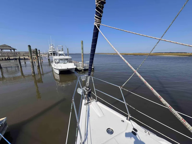 Slide: The Image of Hunter 45 Center Cockpit 2008 sailboat docked at a marina with clear blue skies. - 6