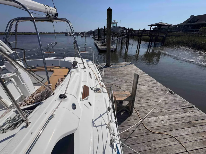 Slide: The Image of Hunter 45 Center Cockpit 2008 sailboat docked at a wooden pier on a sunny day. - 9