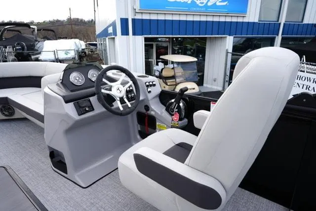 Slide: The Image of 2025 Harris 230 CRUISER boat interior with steering wheel and captain's chair. - 13