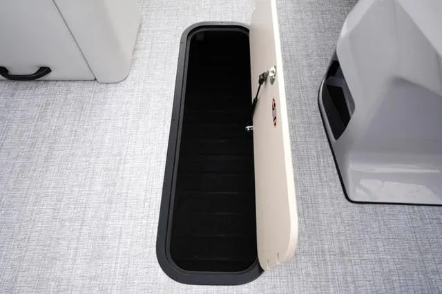 Slide: The Image of Open storage compartment on 2025 Harris 230 Cruiser boat, featuring sleek interior design. - 17