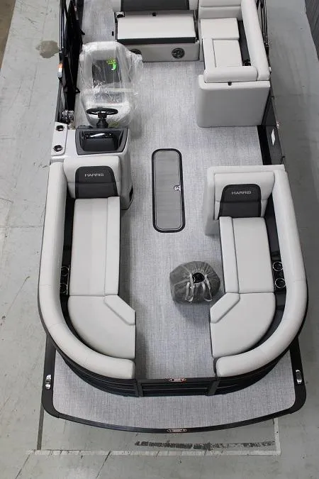 Slide: The Image of 2025 Harris 230 CRUISER pontoon boat interior with modern seating and steering console. - 2