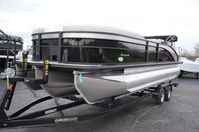 Slide: The Image of 2025 Harris 230 CRUISER pontoon boat on trailer, sleek design, black and silver finish. - 3