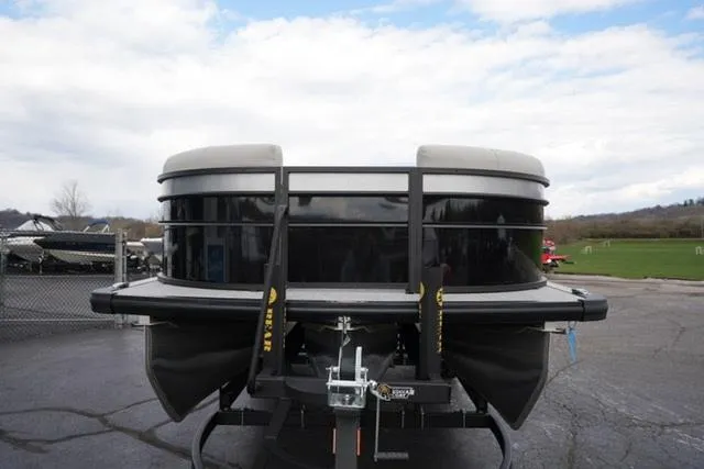 Slide: The Image of 2025 Harris 230 CRUISER pontoon boat on trailer, parked outdoors. - 4