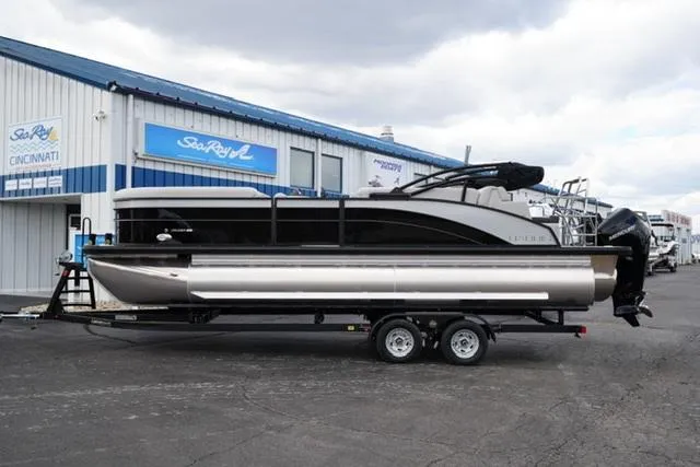 Slide: The Image of 2025 Harris 230 CRUISER pontoon boat on trailer outside dealership. - 5