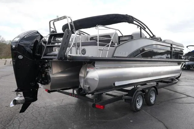 Slide: The Image of 2025 Harris 230 CRUISER pontoon boat on trailer, featuring sleek design and powerful outboard motor. - 9