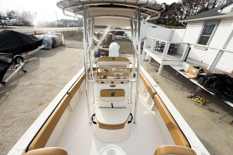 Slide: The Image of 2025 Carolina Skiff 21 Ultra Elite boat interior with tan seating and console. - 11