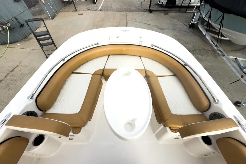 Slide: The Image of 2025 Carolina Skiff 21 Ultra Elite boat interior with tan seating and white table. - 24