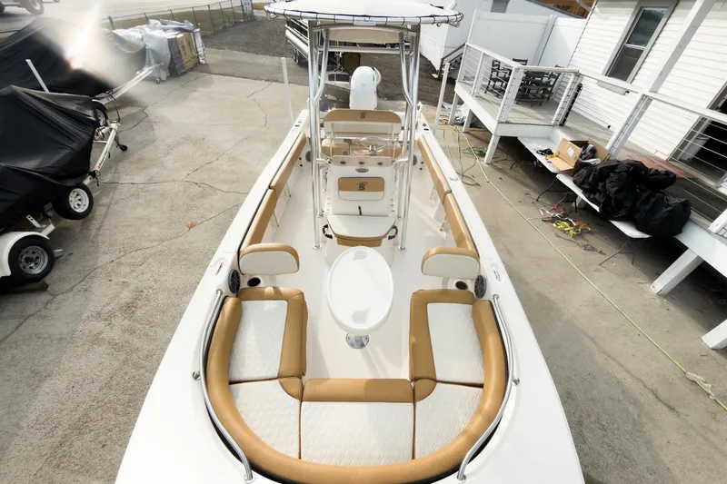 Slide: The Image of 2025 Carolina Skiff 21 Ultra Elite boat, top view, docked, showcasing seating and console. - 9
