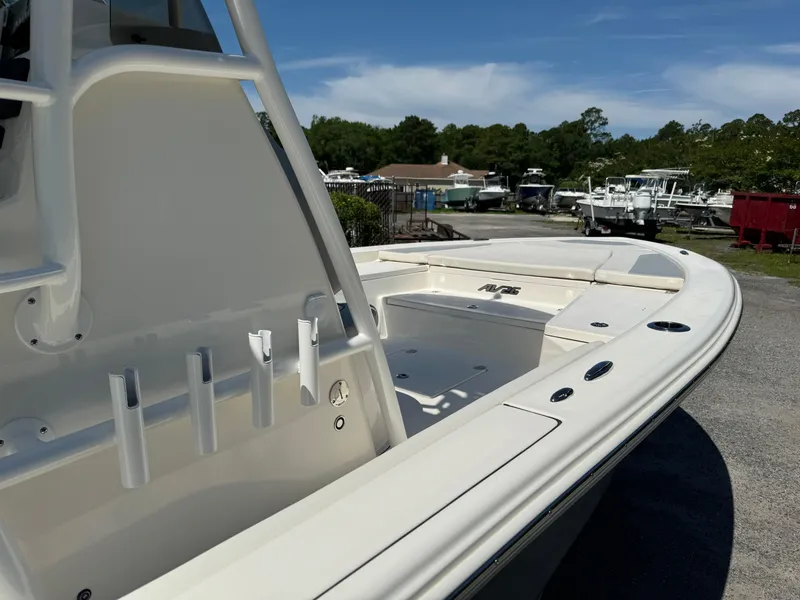 Slide: The Image of 2024 Avenger AV26 boat, sleek design, docked outdoors under clear sky. - 11