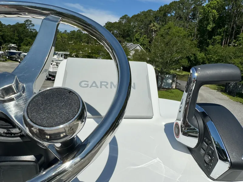 Slide: The Image of 2024 Avenger AV26 boat helm with Garmin navigation and control lever. - 17