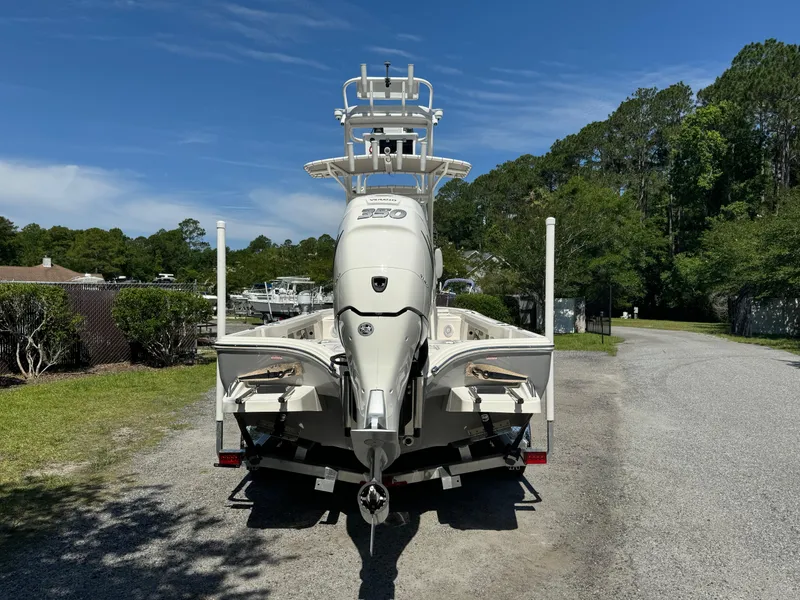 Slide: The Image of 2024 Avenger AV26 boat on trailer, parked outdoors on gravel path. - 6