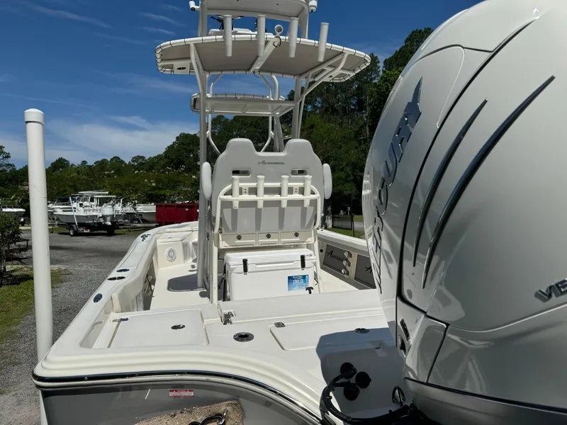 Slide: The Image of 2024 Avenger AV26 boat with Mercury engine, featuring spacious deck and seating. - 7