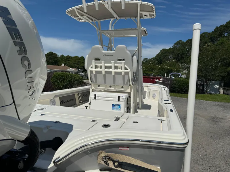 Slide: The Image of 2024 Avenger AV26 boat with Mercury engine, white deck, and T-top in a sunny outdoor setting. - 8
