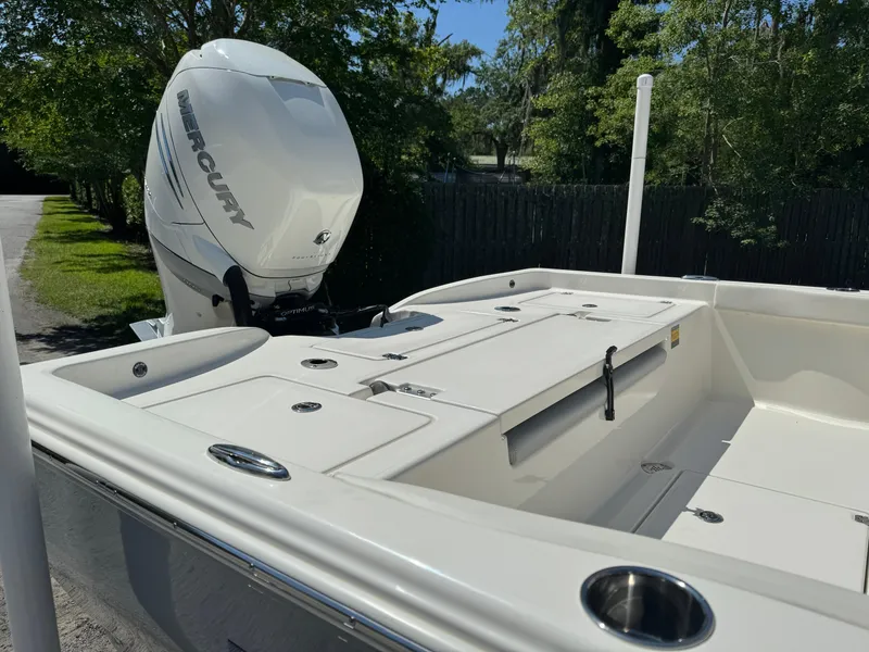 Slide: The Image of 2024 Avenger AV26 boat with Mercury engine, white deck, and storage compartments. - 9