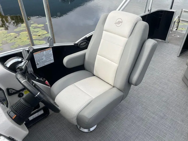 Slide: The Image of Captain's chair on 2018 Starcraft 23 C boat, gray upholstery, near water. - 10