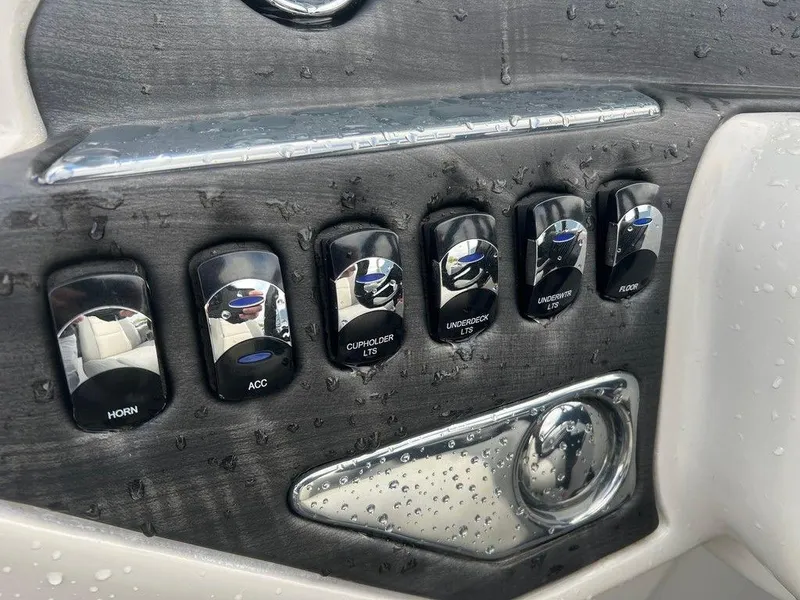 Slide: The Image of Control panel of a 2018 Starcraft 23 C boat with various switches. - 11