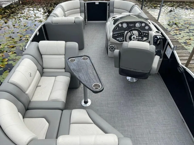Slide: The Image of 2018 Starcraft 23 C pontoon boat interior with gray seating and control panel. - 4
