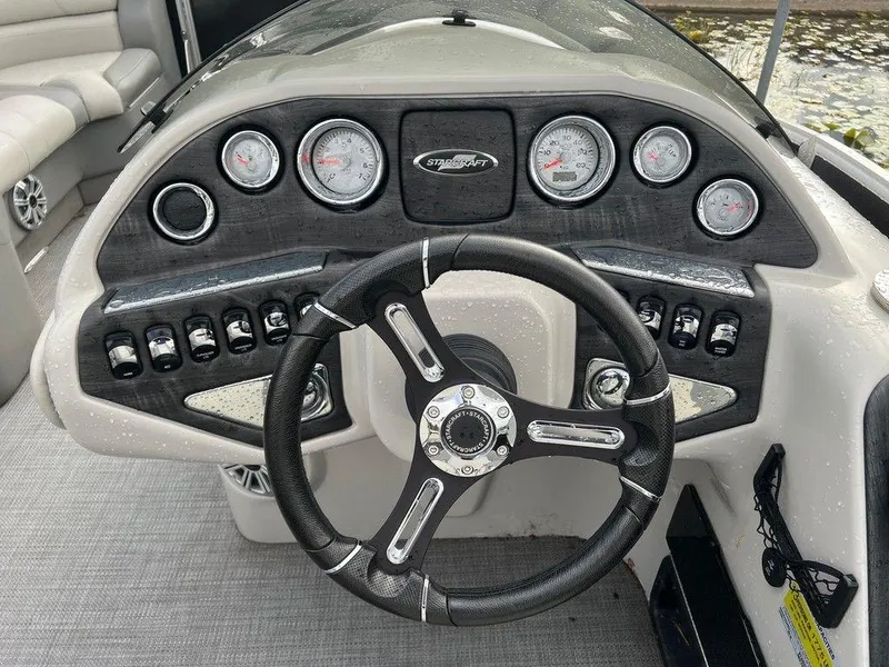 Slide: The Image of 2018 Starcraft 23 C boat dashboard with steering wheel and gauges. - 8