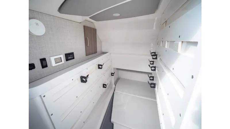 Slide: The Image of Interior of 2022 Regal LS36 boat, featuring sleek white cabinetry and modern design elements. - 14