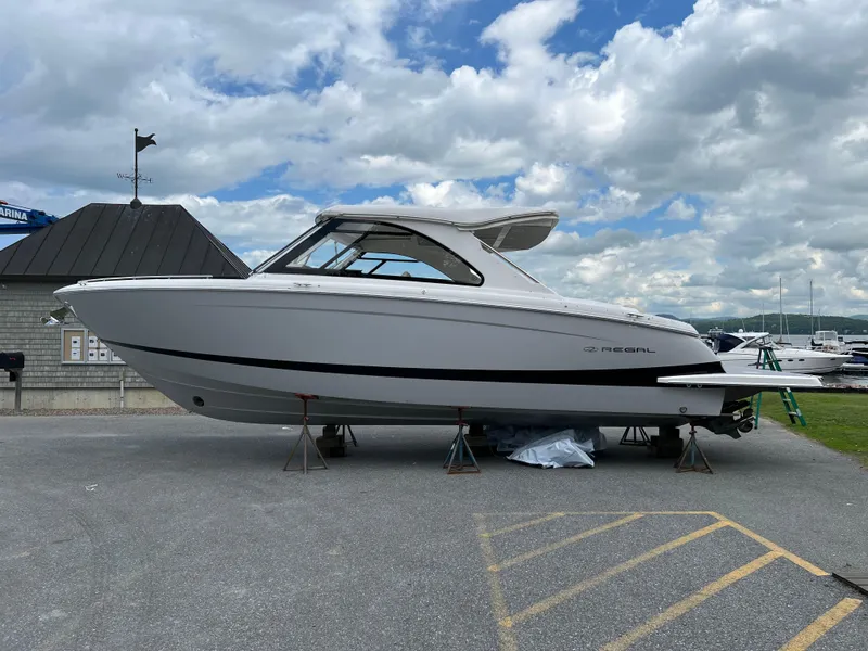 Slide: The Image of 2022 Regal LS36 boat on display at marina under cloudy sky. - 22